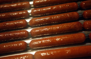 Hot dogs are cooked during a media food tour at Yankee Stadium in New York