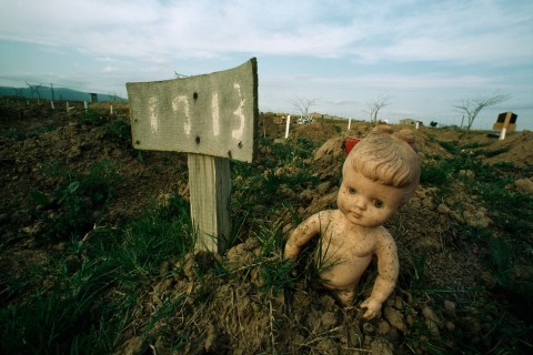 A doll marks the grave of a child