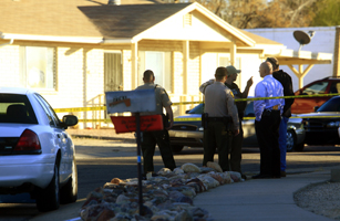 Law enforcement personnel stand outside home of Loughner, identified by federal officials as suspect responsible for the shooting of Giffords, in Tucson, Arizona