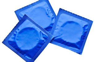 Three condoms in wrappers