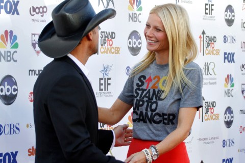 Country musician Tim McGraw greets actress Gwyneth Paltrow as they arrive for the Stand Up To Cancer telethon in Los Angeles, California