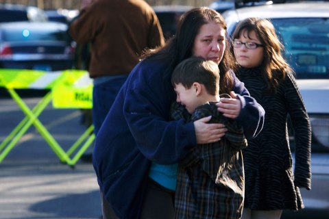 image: A young boy is comforted outside Sandy Hook Elementary School after a shooting in Newtown, Conn., Dec. 14, 2012. 