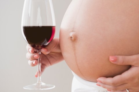 Pregnant woman with glass of wine