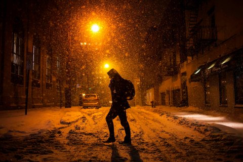 A man walks through the snow in Hoboken